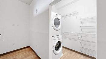 A white laundry room with a washer and dryer.